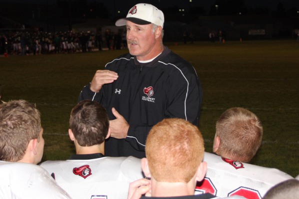 Coach Darin Owens talking to his players on the field